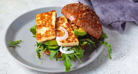 Fried,Halloumi,Burger,With,Avocado,Wedges,And,Arugula.,Vegetarian,Food