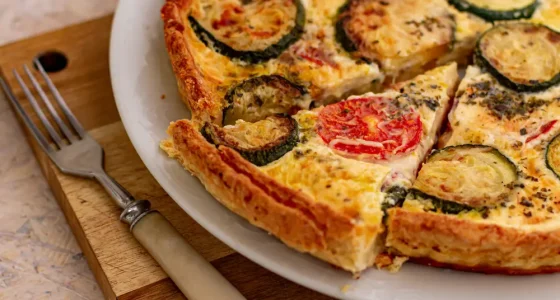 Vegetables,French,Quiche,With,Slice,,On,White,Plate,And,Wooden